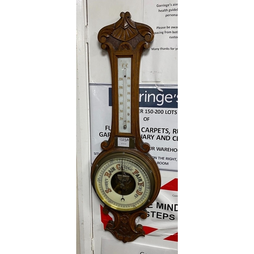 1229A - A Victorian oak cased aneroid wheel barometer and thermometer, height 82cm