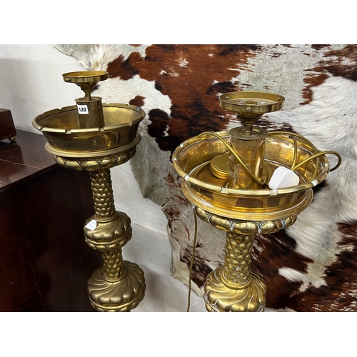 120 - A pair of large Dutch embossed brass altar sticks converted to electricity, height 150cm