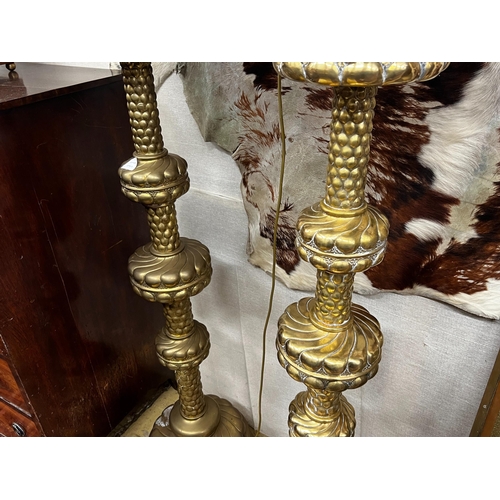 120 - A pair of large Dutch embossed brass altar sticks converted to electricity, height 150cm