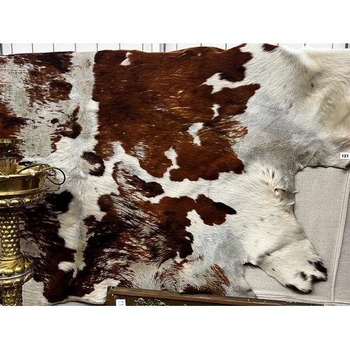 121 - A cow hide rug, width 205cm