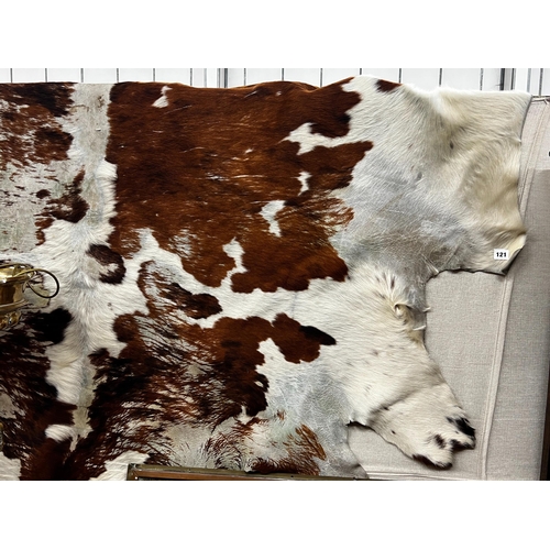 121 - A cow hide rug, width 205cm