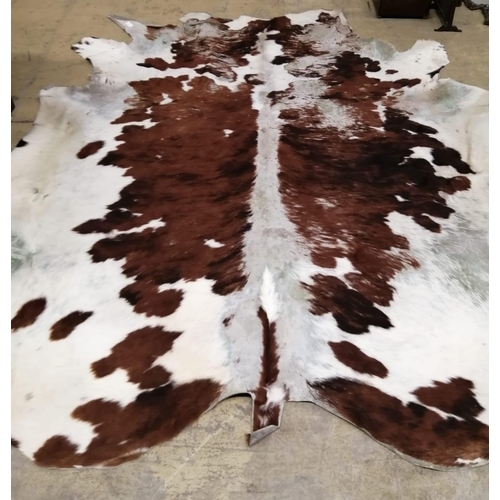 121 - A cow hide rug, width 205cm