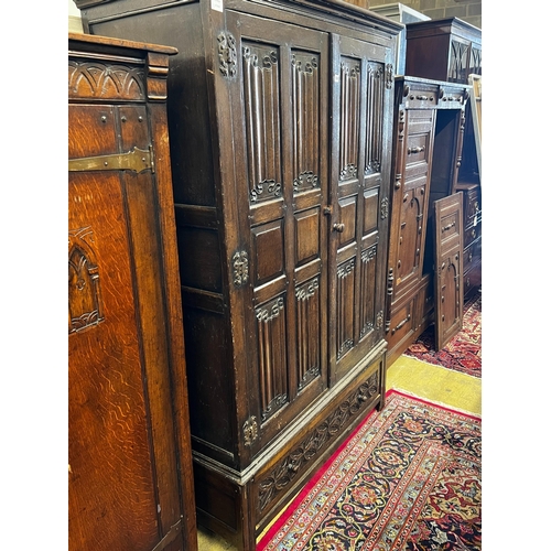 124 - An 18th century style oak linenfold moulded wardrobe, width 123cm, depth 53cm, height 185cm