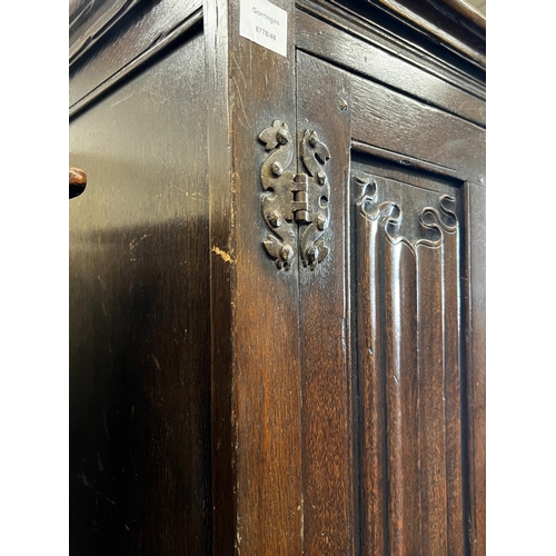 124 - An 18th century style oak linenfold moulded wardrobe, width 123cm, depth 53cm, height 185cm