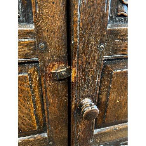 124 - An 18th century style oak linenfold moulded wardrobe, width 123cm, depth 53cm, height 185cm