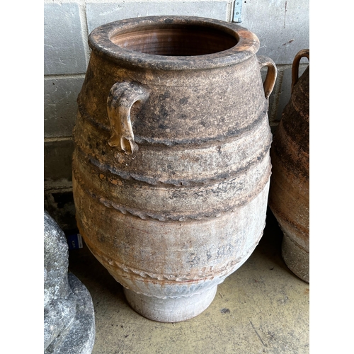 146 - Three Greek terracotta oil jars, largest height 91cm