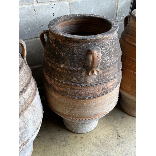 146 - Three Greek terracotta oil jars, largest height 91cm