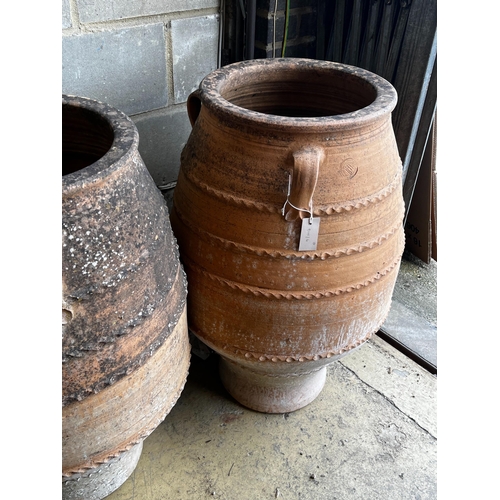 146 - Three Greek terracotta oil jars, largest height 91cm