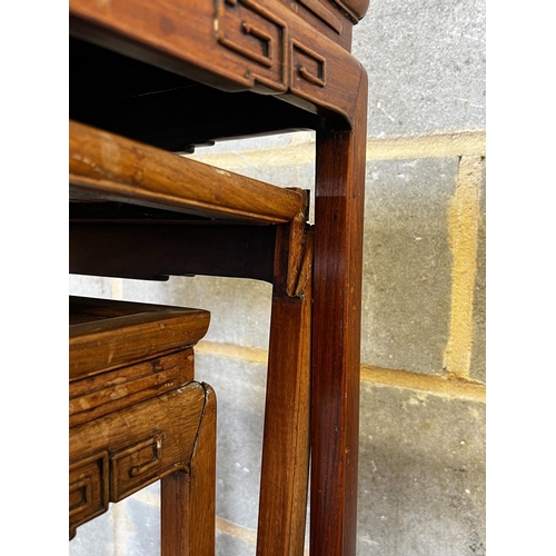 173 - A nest of three Chinese rectangular hardwood tea tables, width 49cm, depth 35cm, height 59cm