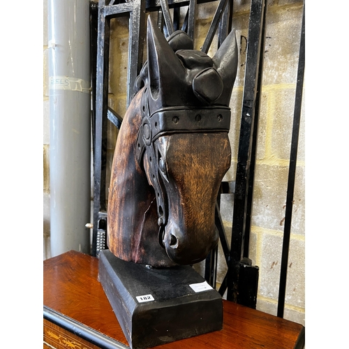 182 - A stylised carved wood model of a horse's head on rectangular plinth, height 59cm