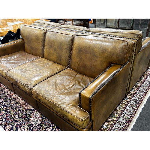 186 - A pair of brown leather brass studded three seater settees, length 200cm, depth 90cm, height 84cm... 