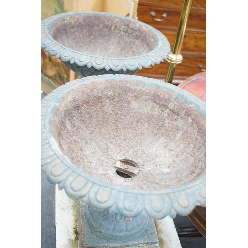 189 - A pair of Victorian painted cast iron campana garden urns on square stone plinths, diameter 51cm, he... 