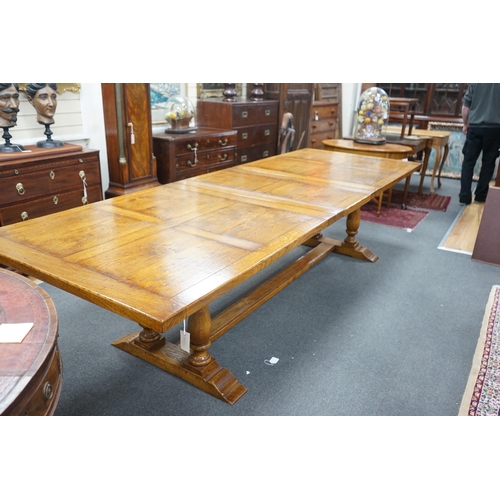 193 - A reproduction 18th century style oak extending refectory dining table, length 306cm extended, one s... 