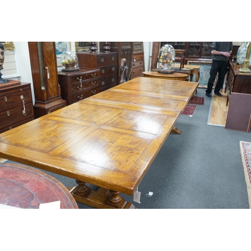 193 - A reproduction 18th century style oak extending refectory dining table, length 306cm extended, one s... 