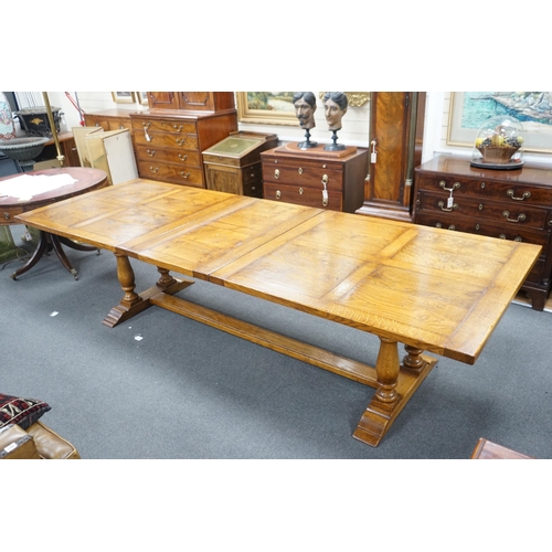 193 - A reproduction 18th century style oak extending refectory dining table, length 306cm extended, one s... 