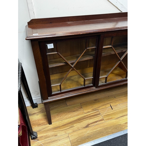 200 - An Edwardian glazed mahogany dwarf bookcase, enclosed by six astragal glazed sliding doors, width 29... 