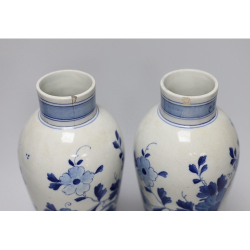 253 - A pair of blue and white Delft vases and covers, 28cm