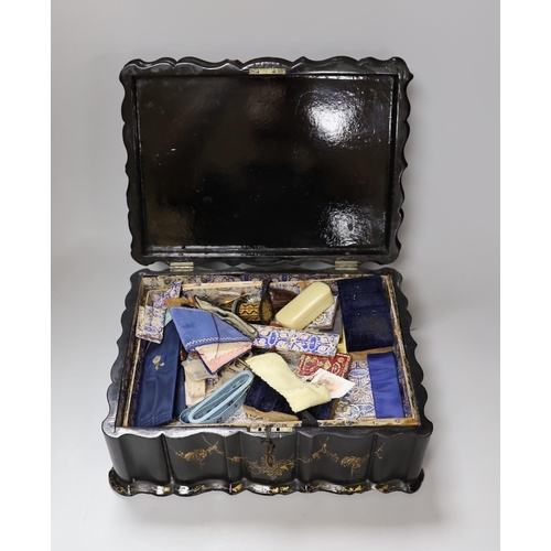 273 - A Victorian papier mache workbox and contents, 32cm