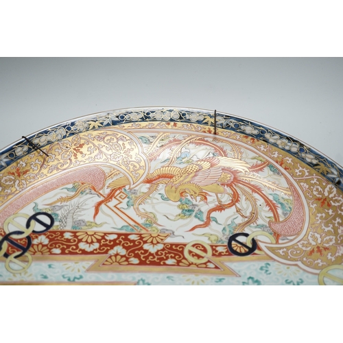 300 - A Japanese Imari dragon and phoenix charger, Meiji period, 46cm diameter