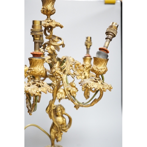 306 - An ornate six branch ormolu cherub candelabrum, converted to a lamp, 54cms high