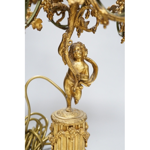 306 - An ornate six branch ormolu cherub candelabrum, converted to a lamp, 54cms high