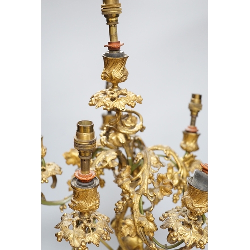 306 - An ornate six branch ormolu cherub candelabrum, converted to a lamp, 54cms high