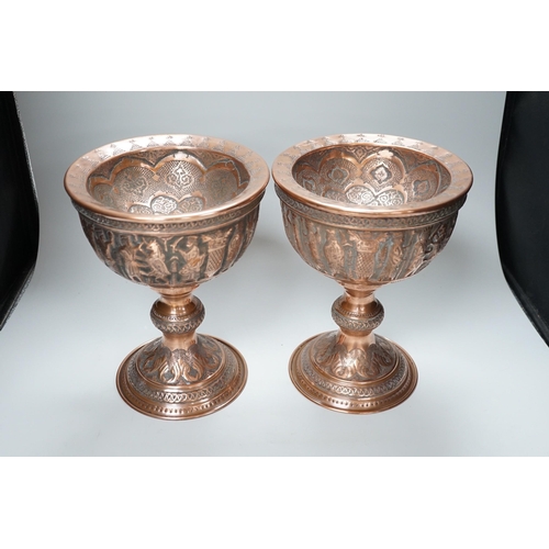 316 - A pair of Persian copper figural decorated chalices, 27cms high