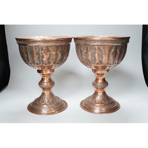 316 - A pair of Persian copper figural decorated chalices, 27cms high