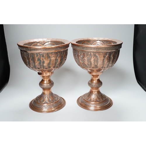 316 - A pair of Persian copper figural decorated chalices, 27cms high