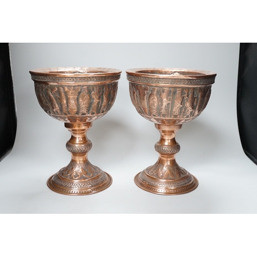 316 - A pair of Persian copper figural decorated chalices, 27cms high