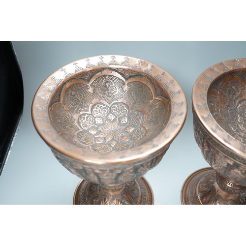 316 - A pair of Persian copper figural decorated chalices, 27cms high