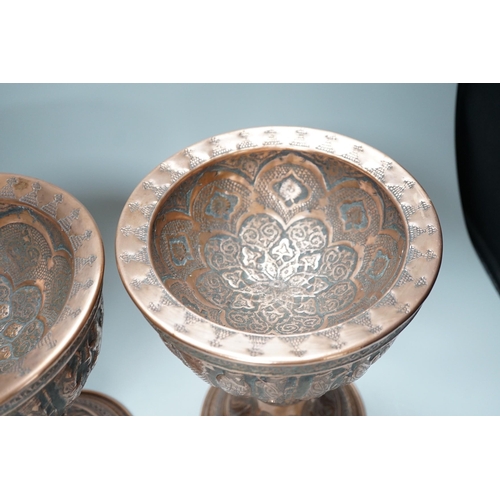 316 - A pair of Persian copper figural decorated chalices, 27cms high