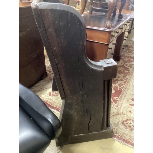 32 - A 17th century and later oak pew with carved misericord, width 82cm, depth 40cm, height 109cm