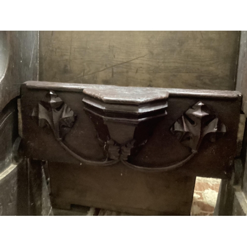 32 - A 17th century and later oak pew with carved misericord, width 82cm, depth 40cm, height 109cm