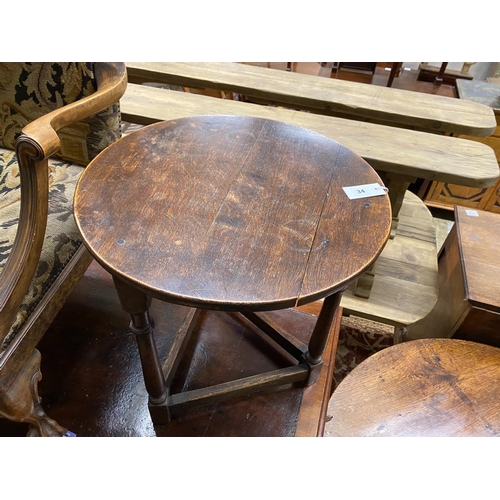 34 - An early 20th century oak cricket table, diameter 55cm, height 61cm