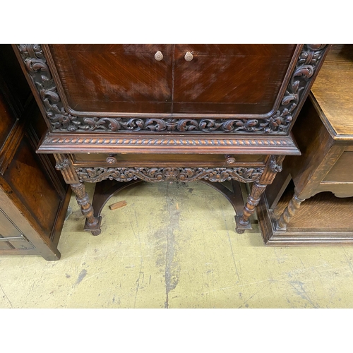 4 - A 17th century style oak cocktail cabinet on stand, width 90cm, depth 50cm, height 137cm