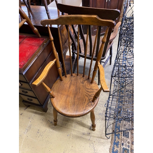 46 - An early 20th century harlequin set of six Windsor elm and beech dining chairs, two with arms