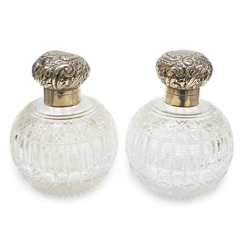 820 - A pair of late Victorian silver mounted cut glass globular scent bottles (a.f.), Haseler Brothers, B... 