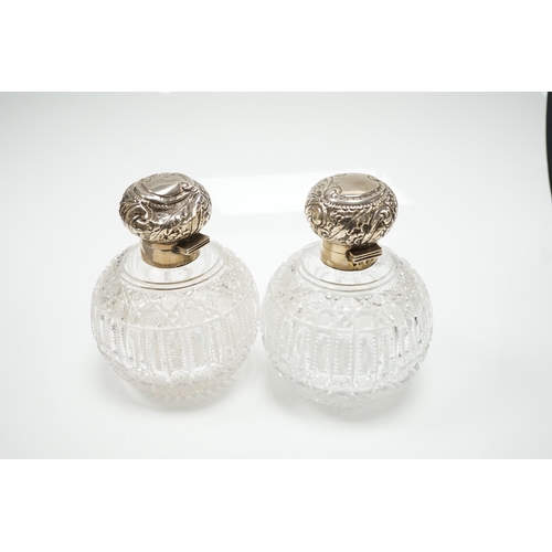 820 - A pair of late Victorian silver mounted cut glass globular scent bottles (a.f.), Haseler Brothers, B... 