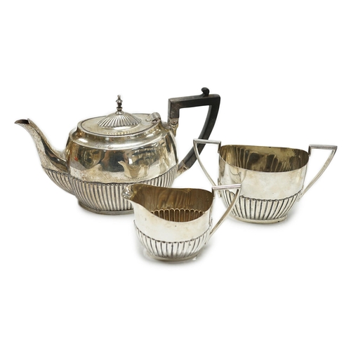 823 - A matched early 20th century silver bachelor's three piece tea set, tea pot, James Dixon & Sons, She... 