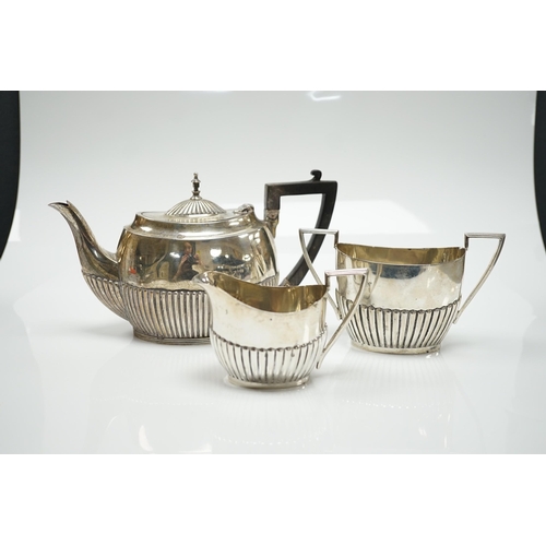 823 - A matched early 20th century silver bachelor's three piece tea set, tea pot, James Dixon & Sons, She... 