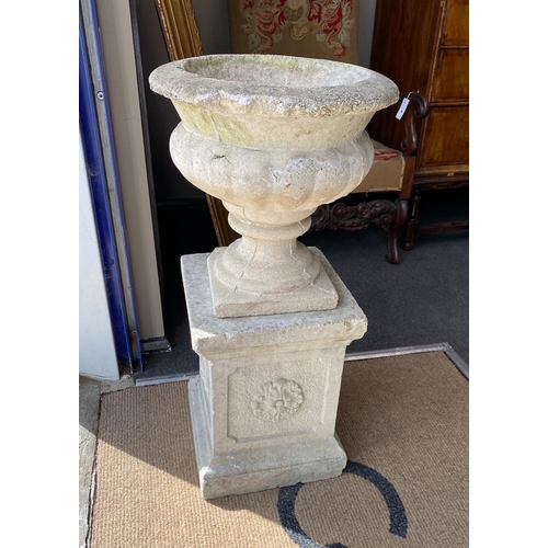 1001 - A pair of reconstituted stone campana garden urns on a near pair of square pedestals, larger height ... 