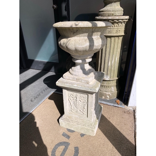 1001 - A pair of reconstituted stone campana garden urns on a near pair of square pedestals, larger height ... 