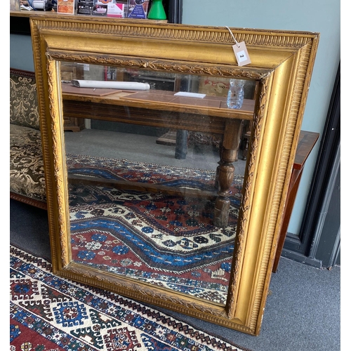 1002 - A 19th century rectangular giltwood and composition wall mirror with later plate, width 95cm, height... 