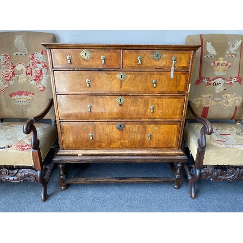 1004 - An 18th century feather banded walnut chest on stand, width 96cm, depth 58cm, height 109cm