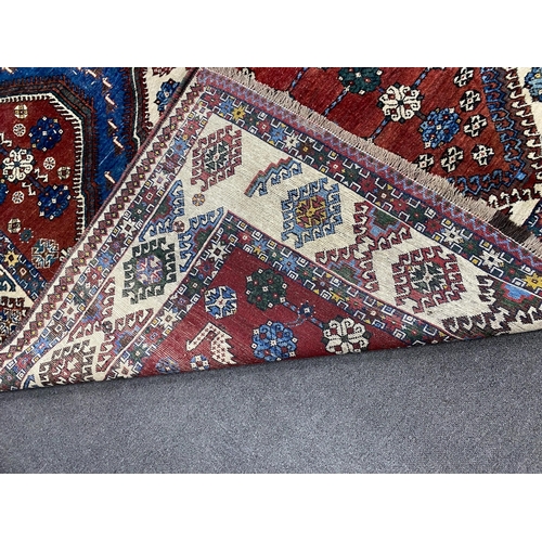 1009 - A Caucasian red ground carpet, 335 x 214cm