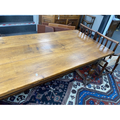 1011 - An 18th century style rectangular oak refectory dining table, length 227cm, depth 92cm, height 76cm... 