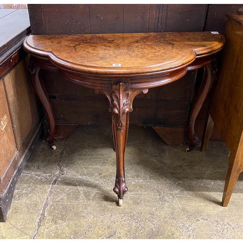 1090 - A Victorian figured walnut D shaped folding card table, width 100cm, depth 51cm, height 74cm