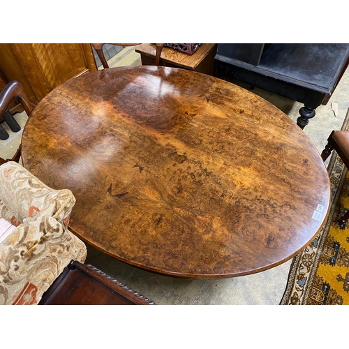 1104 - A Victorian oval figured walnut tilt top loo table, length 152cm, width 118cm, height 69cm