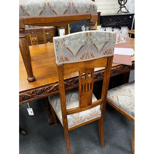 1116 - A set of Art Nouveau carved oak dining chairs, one with arms with original Liberty receipt